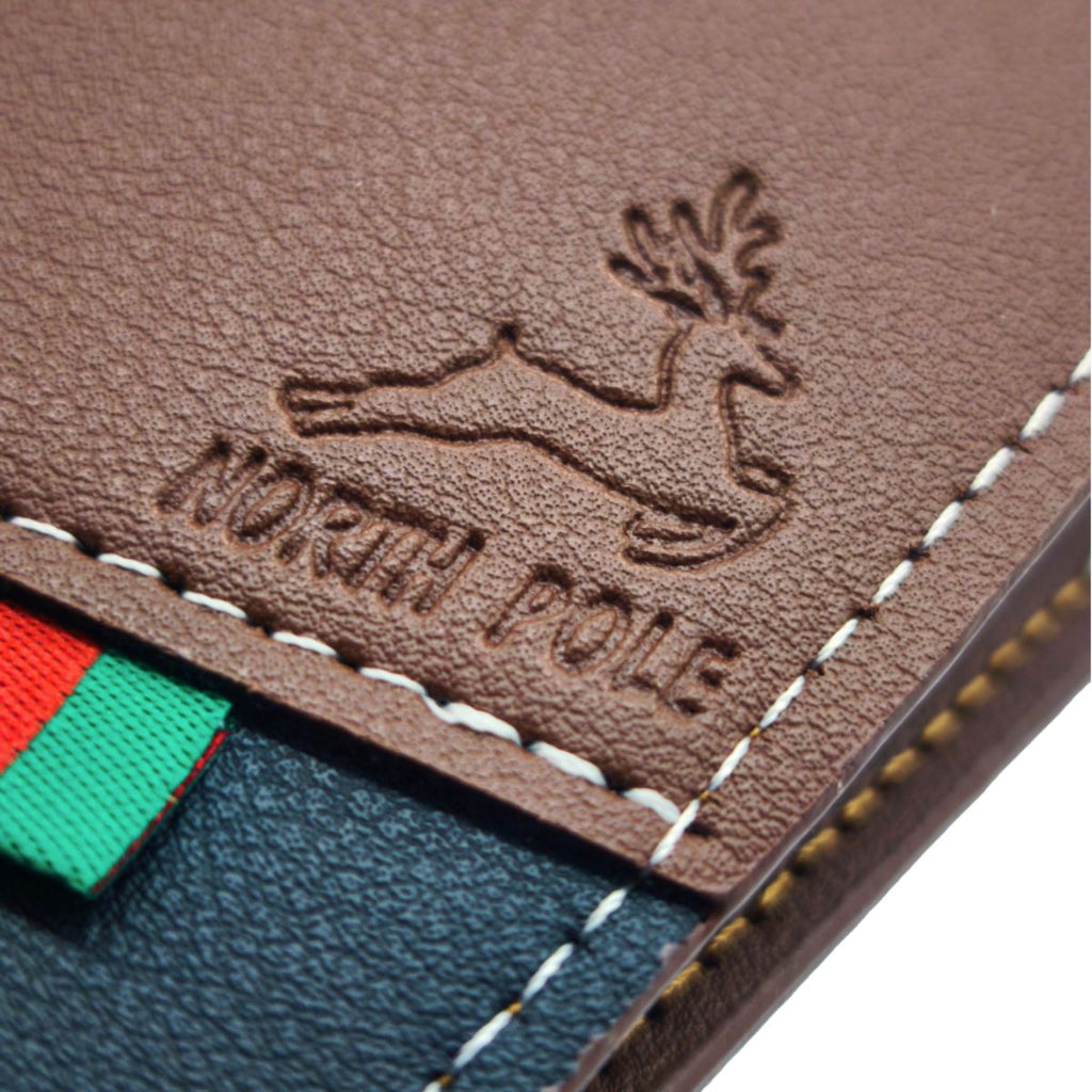 Close-up of the embossed North Pole reindeer crest and contrast stitching on the Deluxe Santa's Lost Wallet